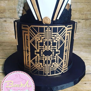 May include: A three-tiered wedding cake decorated in a black and gold Art Deco style. The bottom tier is black with gold geometric designs, the middle tier is white with gold accents, and the top tier is black with gold accents and a white pearl embellishment.