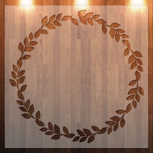 May include: A woodgrain background with a brown leafy wreath cutout. The wreath is centered on the background and has a rustic feel.