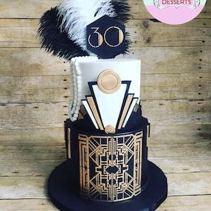 May include: A two-tiered cake decorated in a black and gold Art Deco design. The top tier is white with gold accents and the bottom tier is black with gold geometric patterns. The cake is topped with a black feather boa and a white feather, and a black hexagonal sign with the number "30" in white.