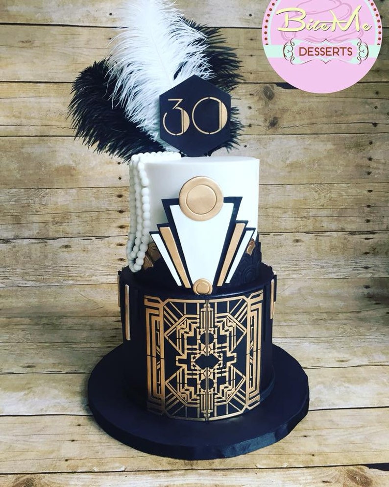 May include: A two-tiered cake decorated in a black and gold Art Deco design. The top tier is white with gold accents and the bottom tier is black with gold geometric patterns. The cake is topped with a black feather boa and a white feather, and a black hexagonal sign with the number "30" in white.