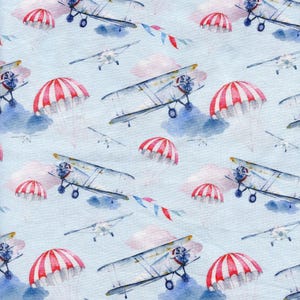 AIRPLANES Cotton fabric. Watercolour bi-planes, clouds and parachutes quilting and sewing cotton by Rose & Hubble. Sold by the metre.