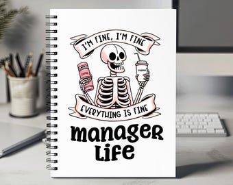 May include: White notebook with a black spiral binding. The notebook has a pink and black illustration of a skeleton holding a coffee cup and a can of coffee. The text on the notebook reads "I'm fine, I'm fine, everything is fine, manager life."