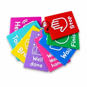 May include: A set of colourful plastic communication cards held together by a red ring. Each rectangular card features a white icon and text, including Stop, Finish, Wait, Wash hands, Well done, Break, and Toilet, designed for visual communication.