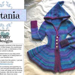 May include: A crochet cardigan with a hood, long sleeves, and a button-up front. The cardigan is made in a variety of shades of blue, purple, and green. The cardigan has a flared hem and a pointed hood. The text "Titania" and "Efilly Designs" is visible in the image.