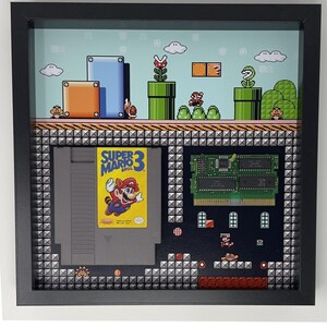 額入りスーパーマリオブラザーズ3のゲームとカートリッジのウォールアート。凹型フレームの分解ディスプレイ、HD光沢紙にカスタムスーパーマリオ3をプリント