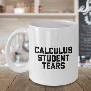 May include: White ceramic coffee mug with black text that reads "Calculus Student Tears".