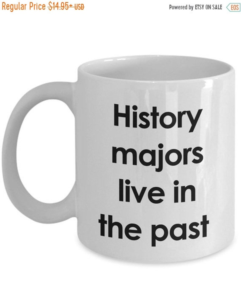May include: White ceramic coffee mug with black text that reads "History majors live in the past".