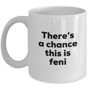Puede incluir: Taza de café de cerámica blanca con texto negro que dice "There's a chance this is feni".