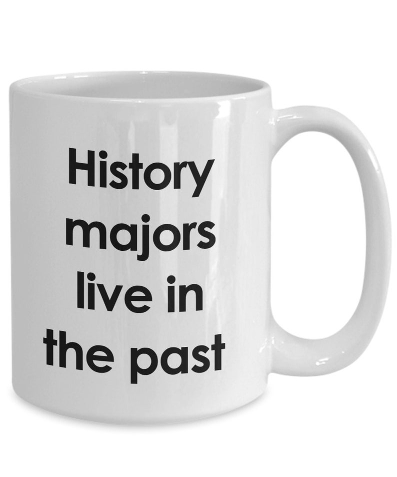 May include: White ceramic coffee mug with black text that reads "History majors live in the past".