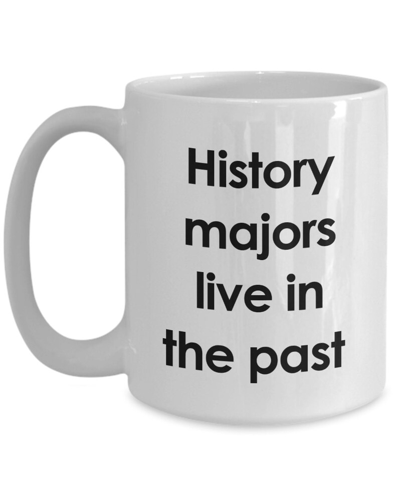 May include: White ceramic coffee mug with black text that reads "History majors live in the past".