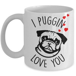May include: White ceramic coffee mug with a black and white illustration of a pug and the text "I puggin' love you" with red hearts.