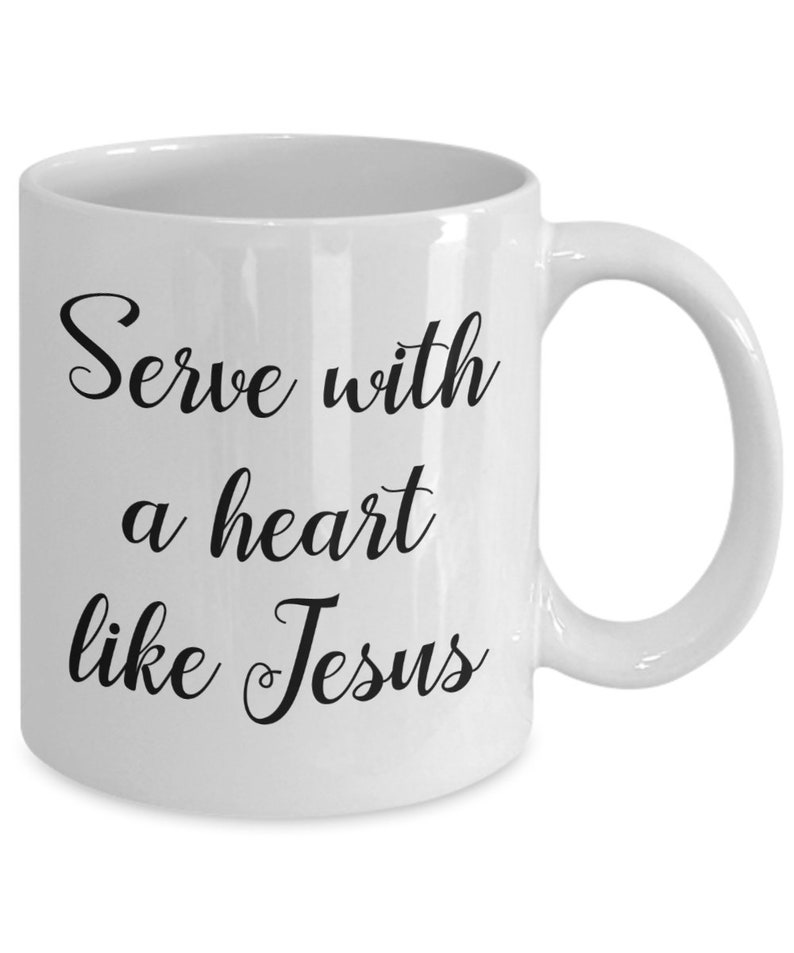 May include: White ceramic coffee mug with black text that reads "Serve with a heart like Jesus".