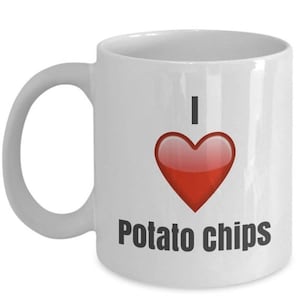 May include: White ceramic coffee mug with a red heart and the text "I love potato chips".