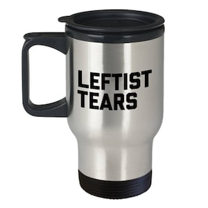 May include: A silver travel mug with a black lid and handle. The mug has the text "Leftist Tears" printed in black on the side.