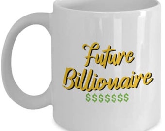 May include: White ceramic mug with a curved handle. The mug features the text "Future Billionaire" in gold script with a black outline, and dollar signs below.