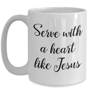 May include: White ceramic coffee mug with black text that reads "Serve with a heart like Jesus".