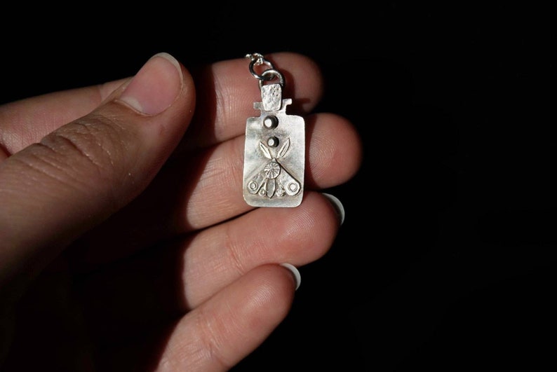 Sterling pendant with moth in jar