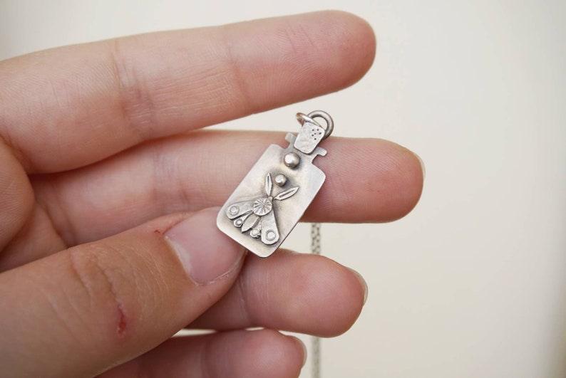 Sterling pendant with moth in jar