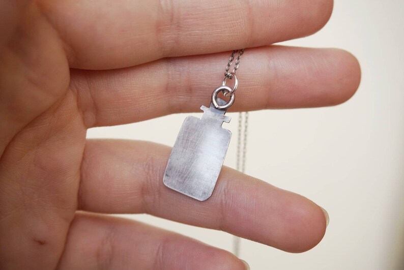 Sterling pendant with moth in jar