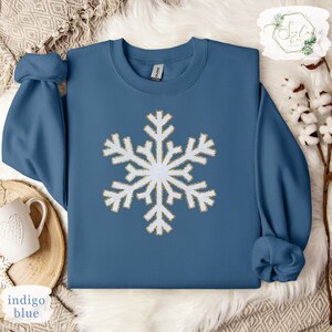 a blue sweater with a white snowflake on it