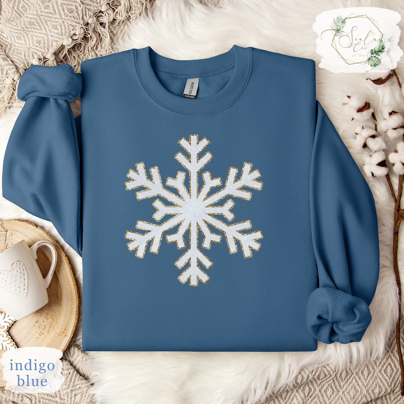 a blue sweater with a white snowflake on it