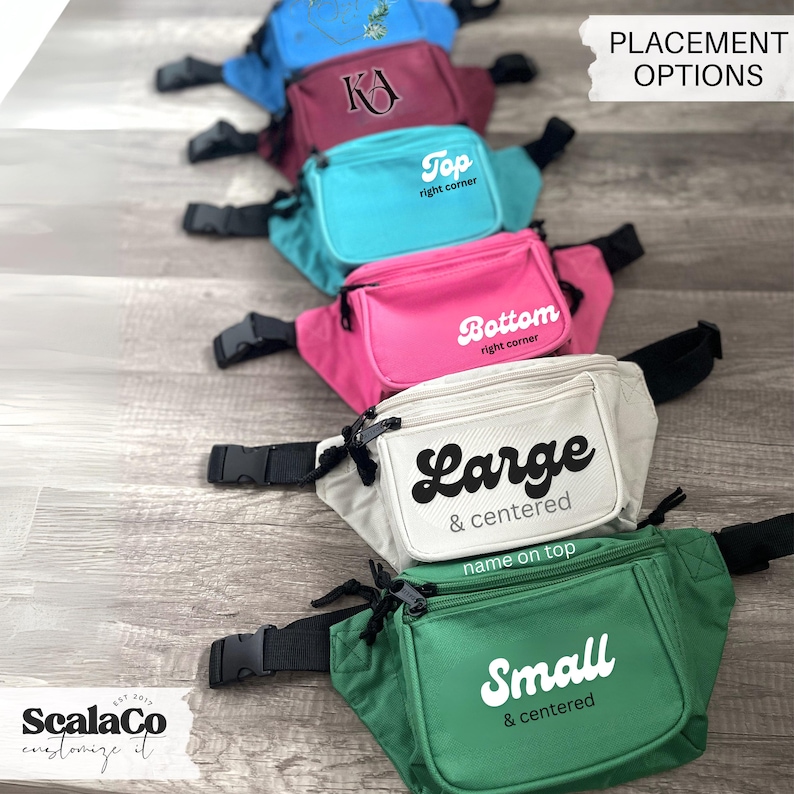 A row of colorful fanny packs with various names printed on them, placed on a wooden surface.
