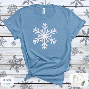 a t - shirt with a snowflake design on it