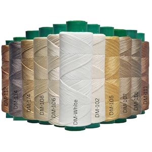May include: A collection of spools of waxed thread in various colors, including white, beige, brown, and gold. Each spool is labeled with a color code. The spools are arranged in a row, with green bases and a white background.