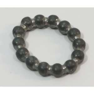 May include: A silver metal ball bearing cage with a circular shape. The cage is made up of a series of small, round balls.