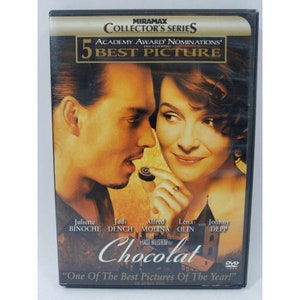 May include: DVD cover for the movie Chocolat, featuring Johnny Depp and Juliette Binoche. The cover is a close-up of the two actors, with Depp holding a chocolate piece. The title of the movie is in large, stylized letters.