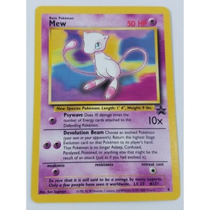 May include: A Pokemon trading card featuring Mew, a pink, cat-like Pokemon with blue eyes. The card is from the Pokemon Trading Card Game and has a light blue background with a rainbow pattern. The card text reads "Basic Pokemon Mew 50 HP".