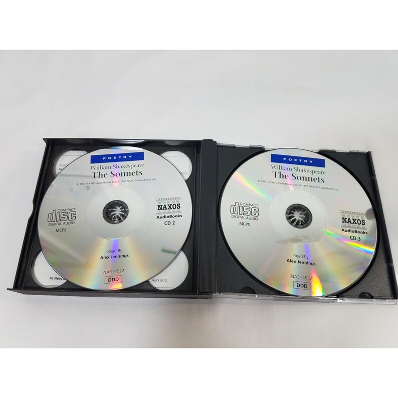 May include: Two compact discs in a black case. The discs are silver with black text, featuring the title "The Sonnets" by William Shakespeare. The discs are labeled "NAXOS AudioBooks" and "CD 2" and "CD 3".