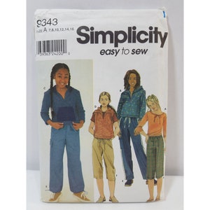 May include: Simplicity sewing pattern #9343, easy to sew, for sizes 7, 8, 10, 12, 14, and 16. The pattern includes four different styles of pants and tops for girls. The models are wearing a variety of colors and patterns, including blue, green, brown, and orange.