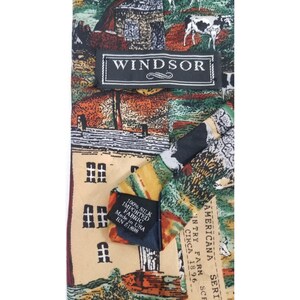 May include: A silk tie with a countryside scene. The tie features a repeating pattern of farm buildings, cows, and fields in shades of green, brown, and beige. The label reads "WINDSOR". The tie is made of 100% silk imported fabric.