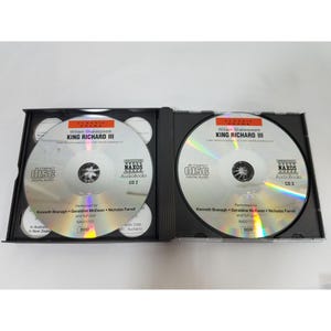 May include: Two open black CD cases with silver discs. The CDs are labeled "William Shakespeare King Richard III" and "Naxos AudioBooks." The cases are open, revealing the CDs and additional text. The CDs are labeled CD 2 and CD 3.