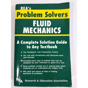 May include: A softcover textbook titled REA's Problem Solvers Fluid Mechanics: A Complete Solution Guide to Any Textbook. The cover is dark green with a yellow horizontal band, featuring white text detailing its use for homework and exams.