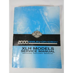 May include: A blue and black Harley-Davidson service manual for XLH models from the year 2000. The cover features a motorcycle graphic and the Harley-Davidson logo.