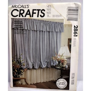 May include: McCall's Crafts pattern number 2861 for window dressing. The pattern shows a blue and white curtain with a ruffled top and a gathered bottom. The pattern includes instructions for making the curtains and the text "One Envelope Une Pochette".