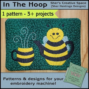 May include: A bee-themed embroidery design featuring a teapot and a cup with a steamy design. The design is on a green fabric background. The text "In The Hoop by Sher" is visible in the lower right corner of the image.