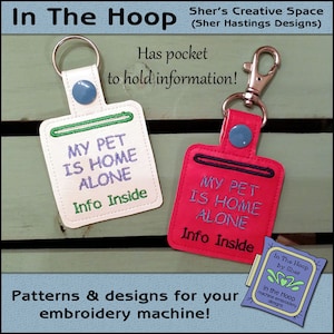 May include: Two white and red keychains with a pocket to hold information. The keychains are embroidered with the text "My Pet Is Home Alone" and "Info Inside".