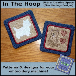 May include: Two square fabric coasters with embroidered dog and heart designs. The coasters have a blue floral border, a tan center, and a red trim. The text "In The Hoop" and "Patterns & designs for your embroidery machine!" are also visible.