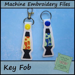 May include: Two key fobs with a lava lamp design. One has a yellow and orange design, the other has a blue and green design. Each has a metal keyring and a snap closure. The text "Machine Embroidery Files" and "Key Fob" are visible.