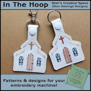May include: Two white embroidered keychains shaped like a church building with a cross on top. The keychains have brown and blue details and are attached to silver key rings. The image includes the text "In The Hoop by Sher" and "In the Hoop machine embroidery designs".