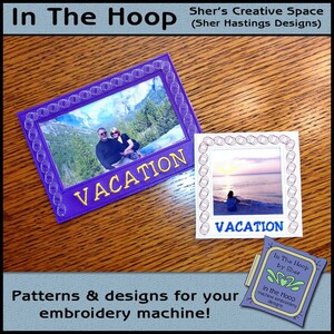 May include: Two embroidered photo frames with a purple and white background. The frames are decorated with a circle design and the word "VACATION" is embroidered in yellow on each frame. The frames are on a wooden surface.