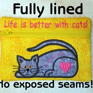 May include: A yellow zippered pouch with a cat design and the text "Life is better with cats!" embroidered on it. The pouch is fully lined and has no exposed seams.