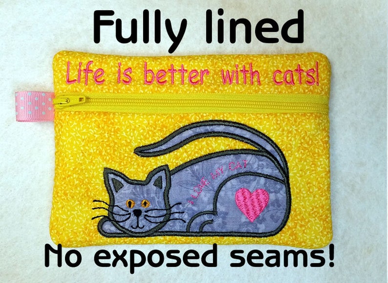 May include: A yellow zippered pouch with a cat design and the text "Life is better with cats!" embroidered on it. The pouch is fully lined and has no exposed seams.