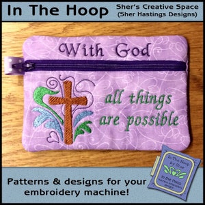 May include: Purple zippered pouch with a cross and the text "With God all things are possible". The pouch is embroidered with a cross and floral designs. The text "In The Hoop by Sher" is visible in the lower right corner.