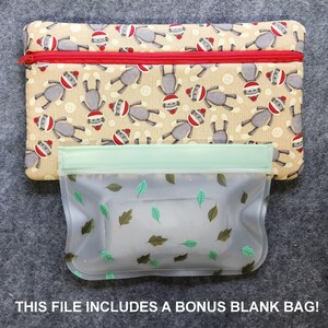 K&ouml;nnte beinhalten: Eine beige Rei&szlig;verschlusstasche mit rotem Rei&szlig;verschluss und einem Muster aus Sockenaffen mit Weihnachtsm&uuml;tzen. Darunter befindet sich eine transparente Tasche mit gr&uuml;nem Oberteil und Bl&auml;ttermuster. Der Text unten lautet: DIESE DATEI ENTH&Auml;LT EINE BONUS-LEERE TASCHE!