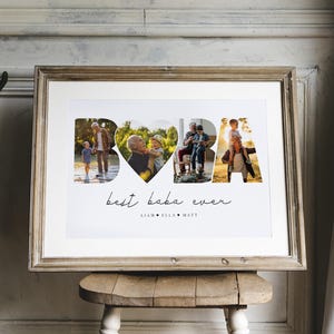 May include: A framed photo collage featuring the word "BABA" composed of family photos. Below, the text reads "best baba ever", with names beneath. The frame is a light brown colour and the collage is displayed on a wooden stool.