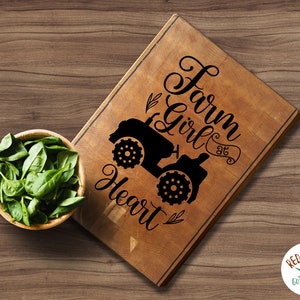 May include: A wooden cutting board with the text "Farm Girl at Heart" and a silhouette of a tractor.